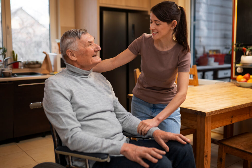 woman assisting man in assisted living community